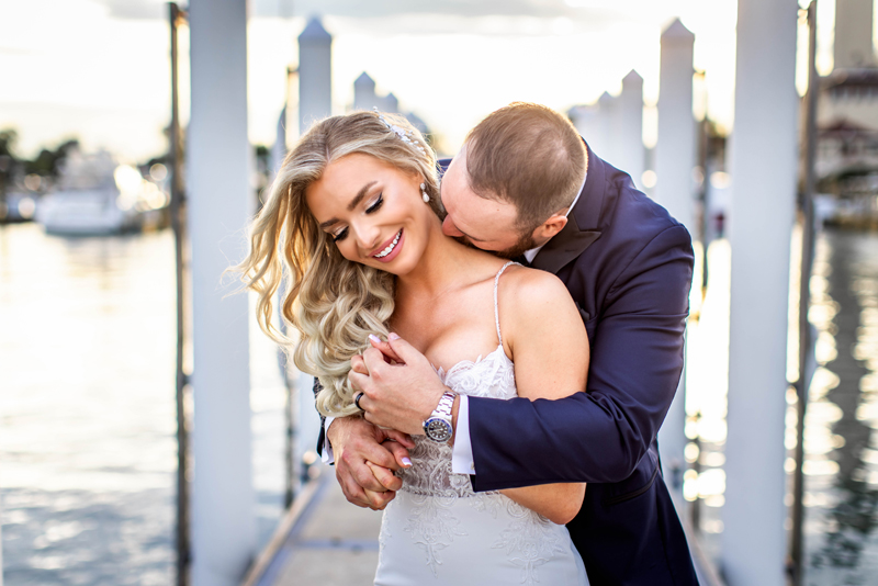 Wedding Photography, Groom standing behind bride kissing her on the neck